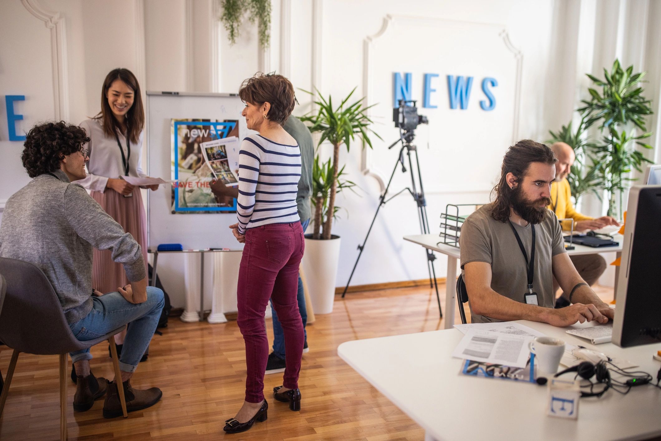 Editorial team working together in a busy newsroom