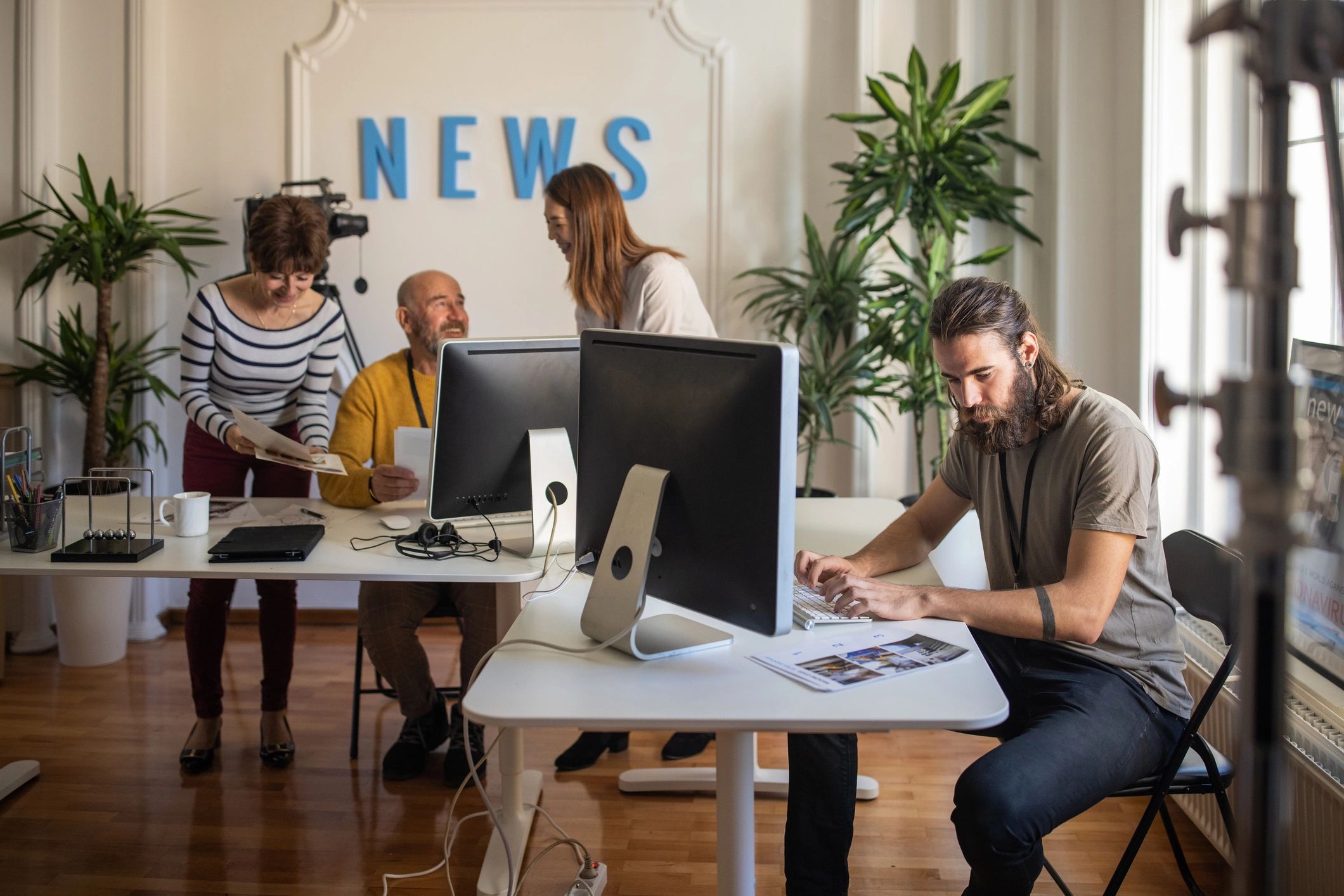 Journalists collaborating in a modern newsroom